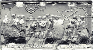 In the most famous of the panels, Roman soldiers carry the Jerusalem Temple spoils on parade, including the menorah, the showbread table and trumpets, which were then deposited in Rome’s Temple of Peace. Courtesy Yeshiva University Arch of Titus Digital Restoration Project. http://www.biblicalarchaeology.org/daily/biblical-sites-places/temple-at-jerusalem/jewish-captives-in-the-imperial-city/